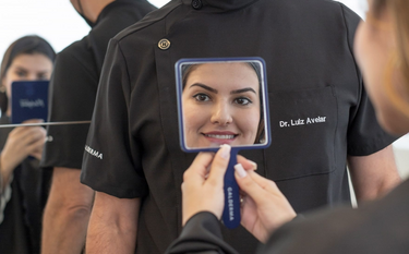 Fillers, smiling woman holding a mirror